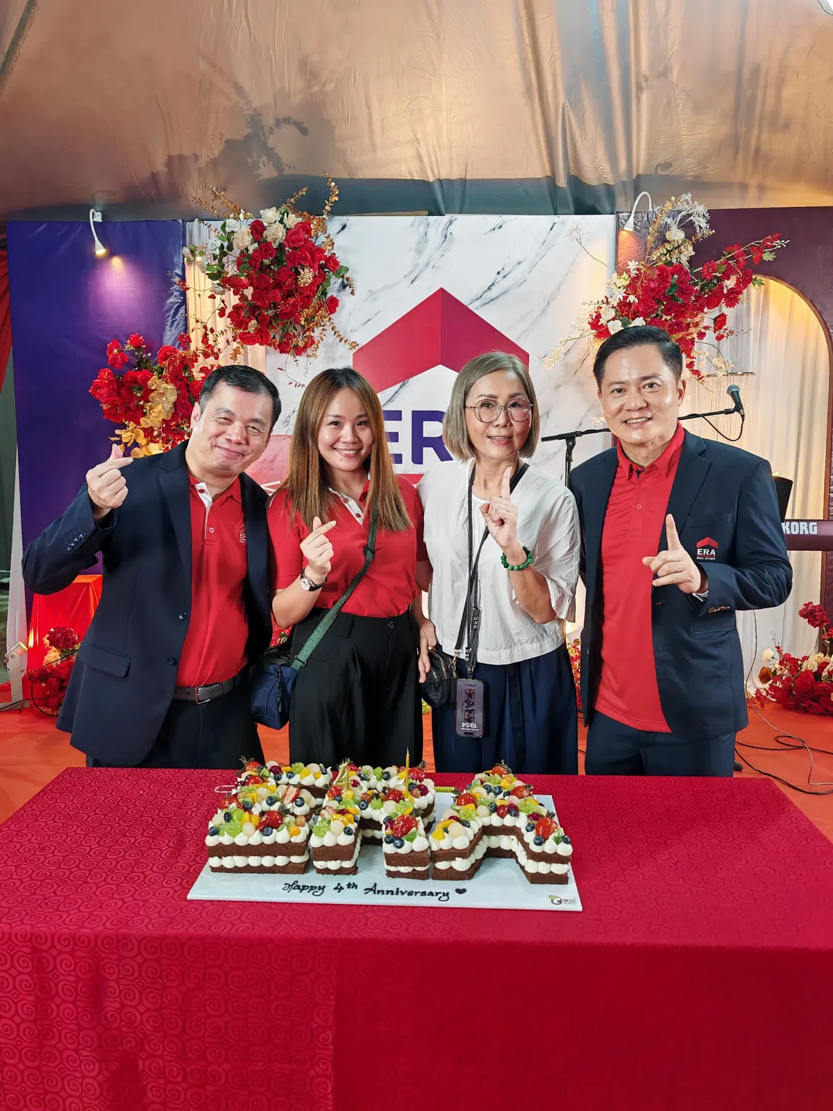 Eve Ang and ERA leaders cutting the branch anniversary cake