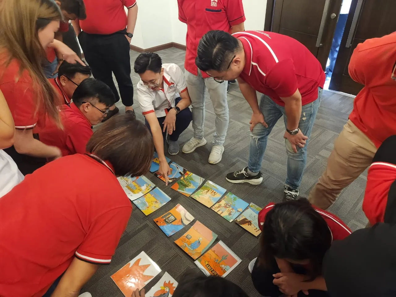 Team members working together on a floor activity during a training workshop